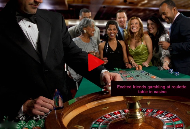 Excited-friends-gambling-at-roulette-table-in-casino